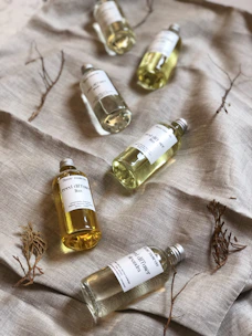 several white labeled bottles on gray cloth