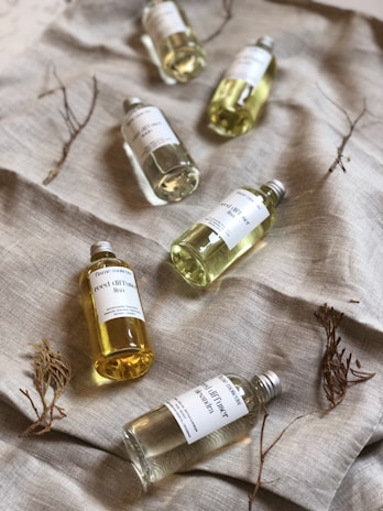 several white labeled bottles on gray cloth
