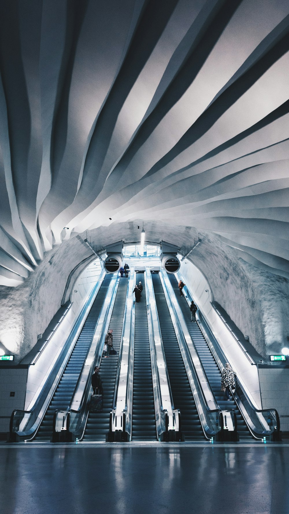 people walk on escalator inside building