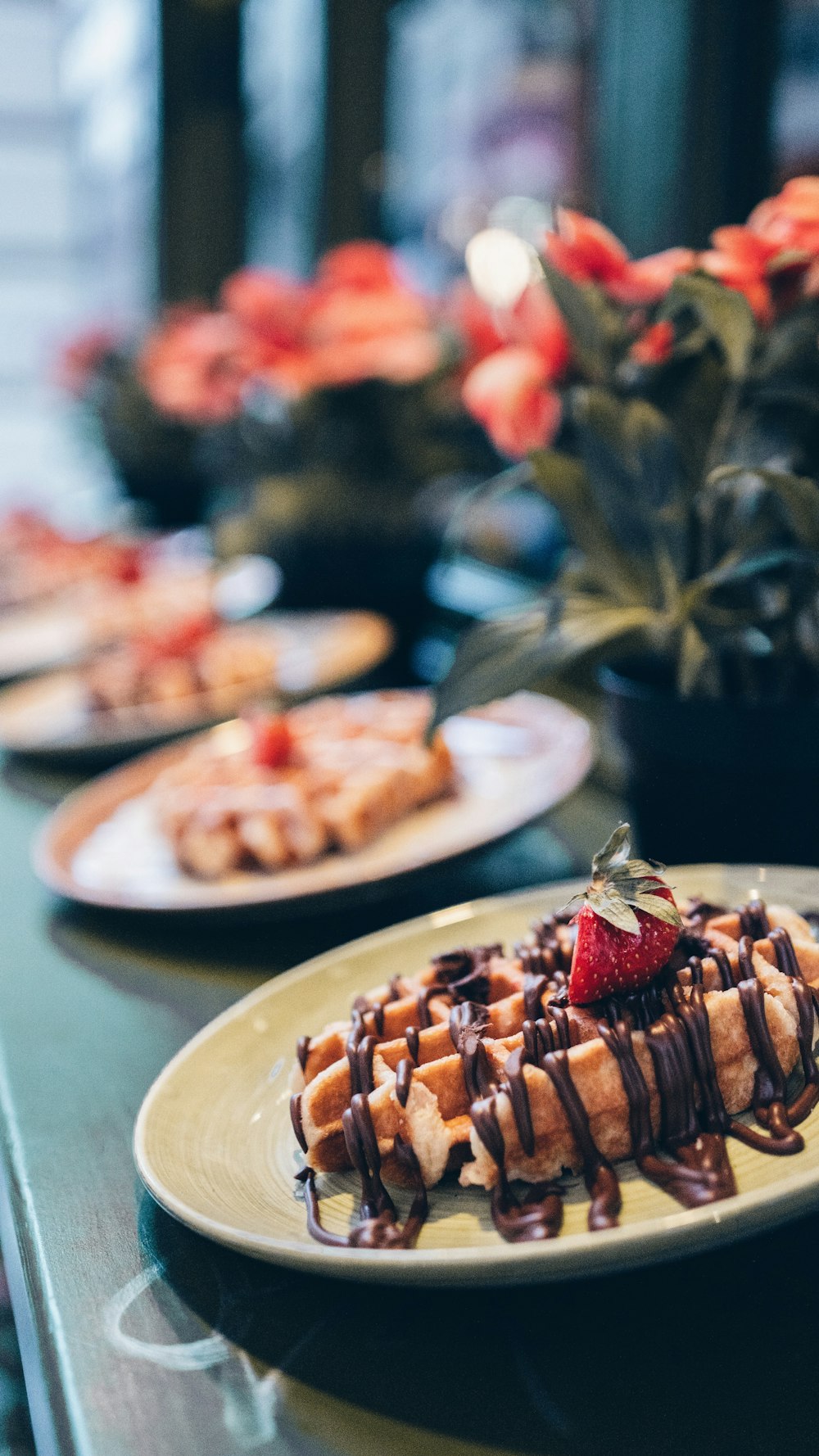 chocolate waffle and pink strawberry on plate