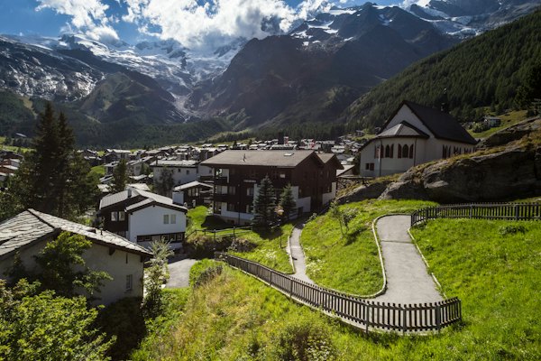 White painted houses near mountain ranges — Saas-Fee, Switzerland