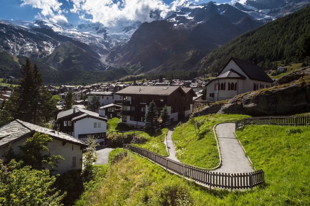 white painted houses near mountain ranges