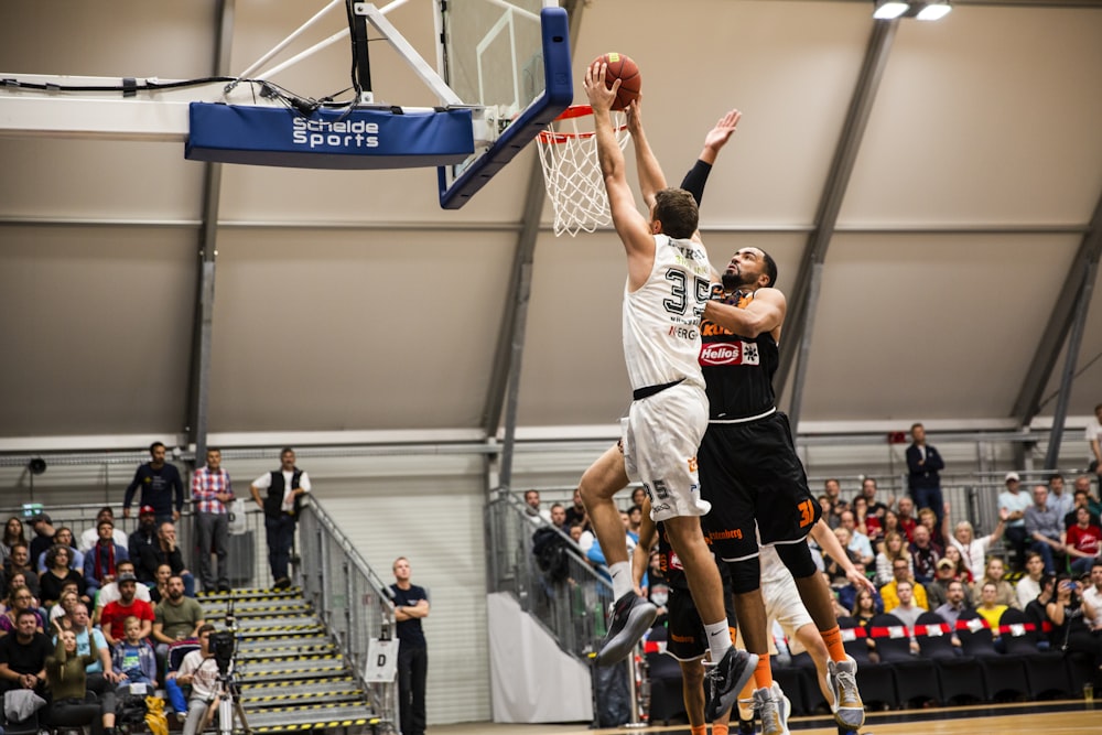 man holding ball dunk in ring