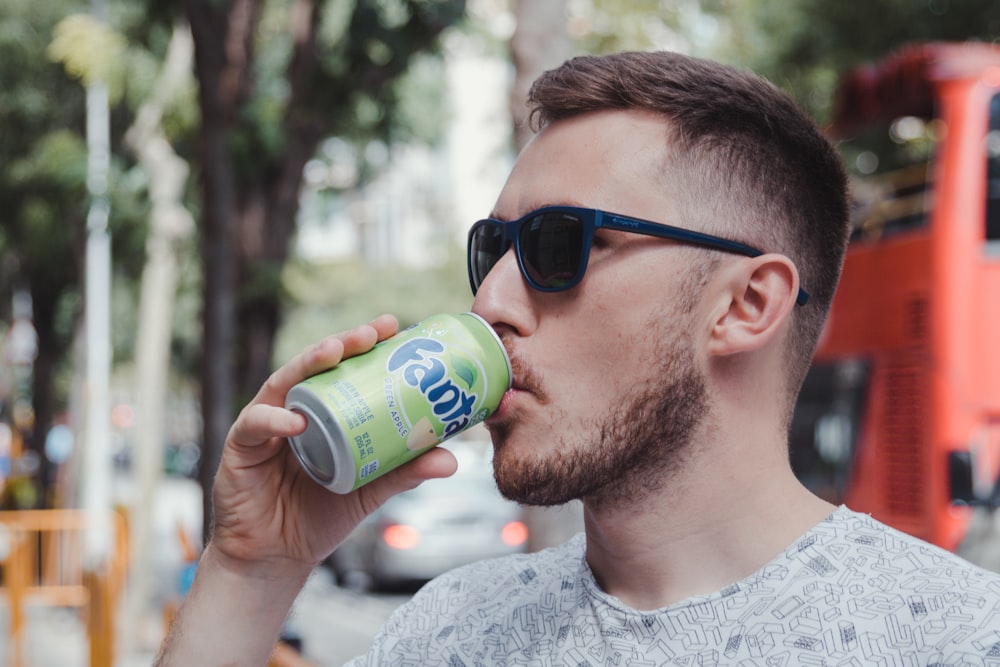 man drinking fanta soda can