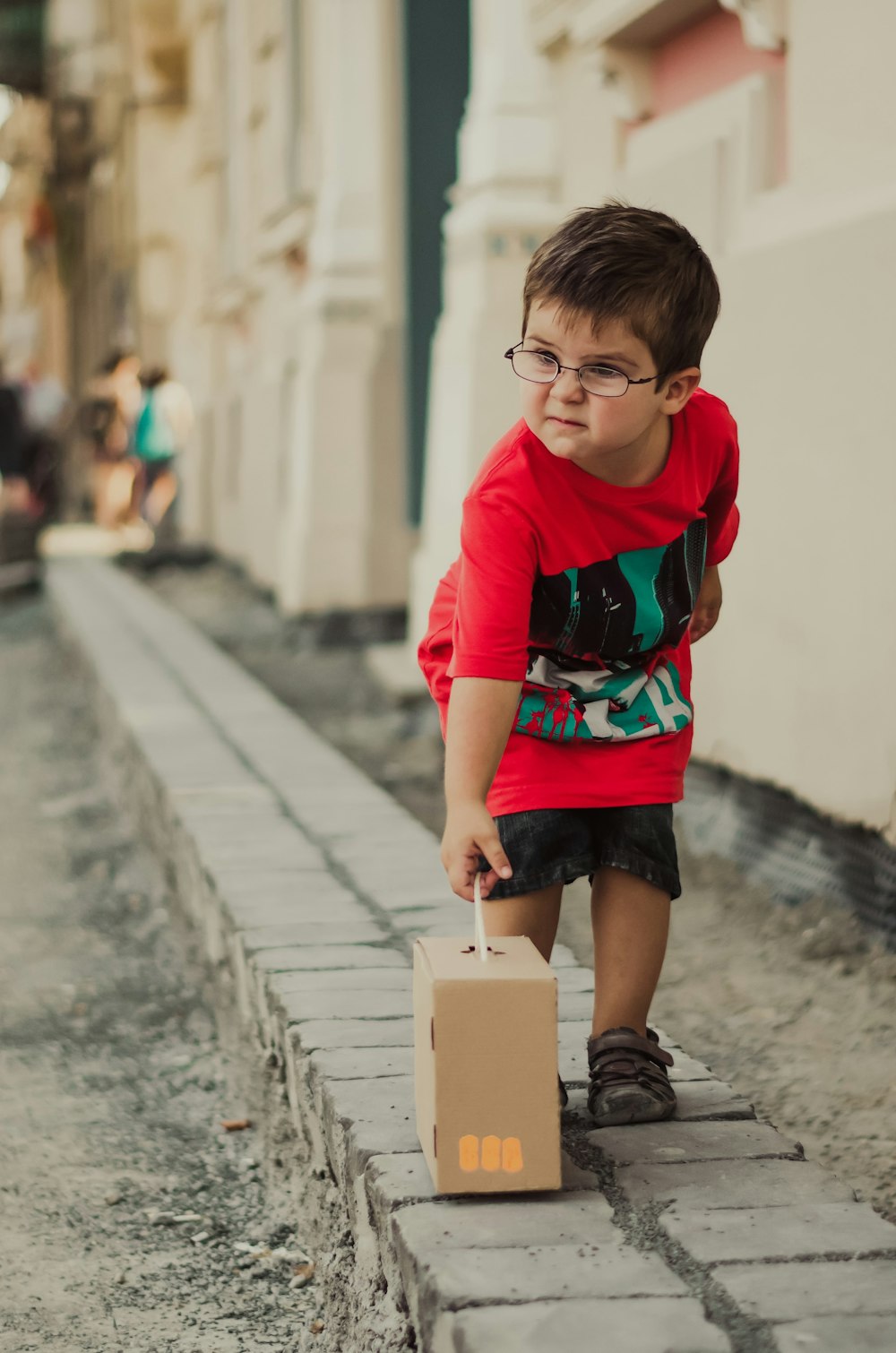 boy holding a brown box