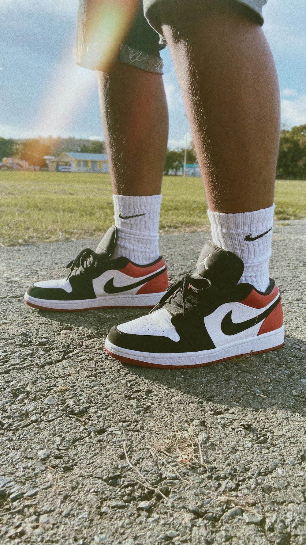 person in black-white-red Air Jordan low-top sneakers