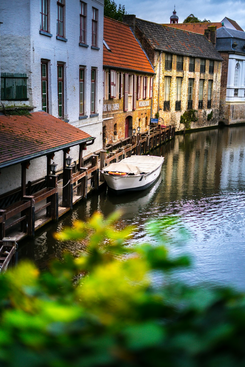 white boat beside house