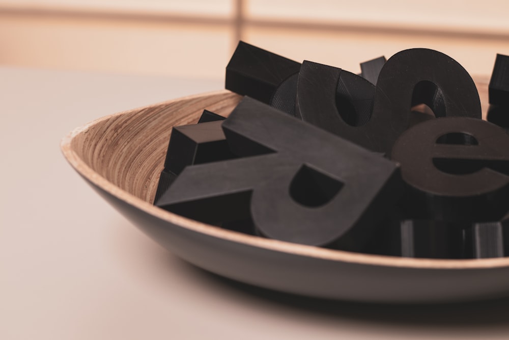 black plastic letters on a brown bowl