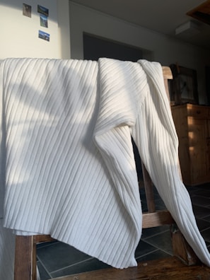 A blanket folded neatly on a chair.