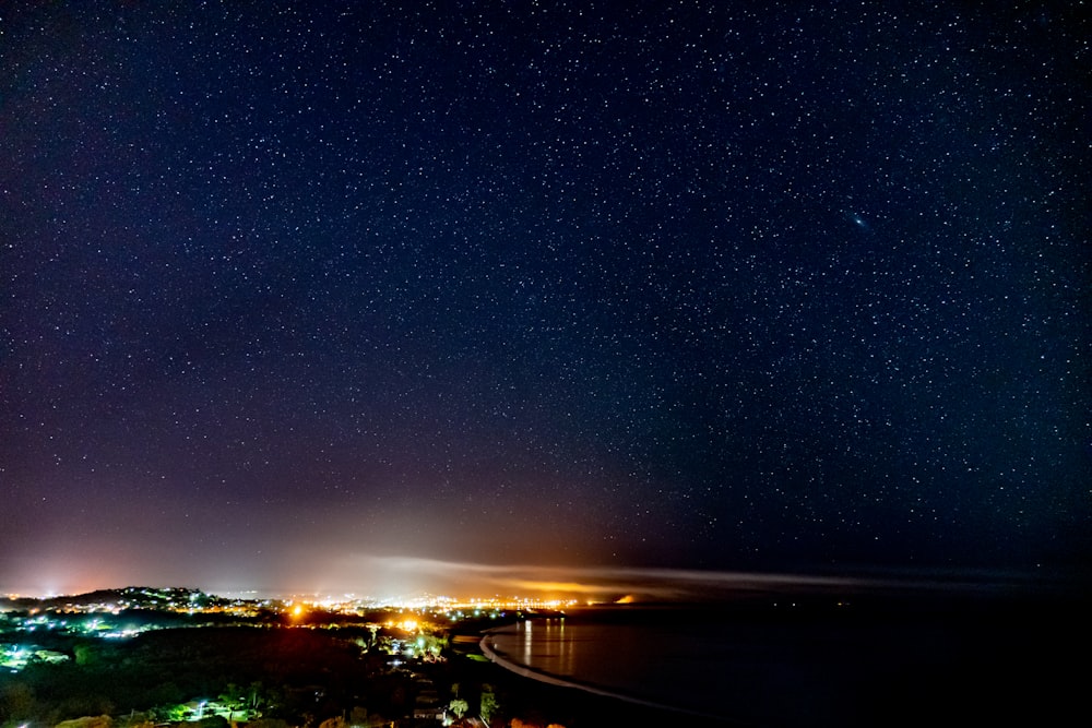 lit city under a starry sky