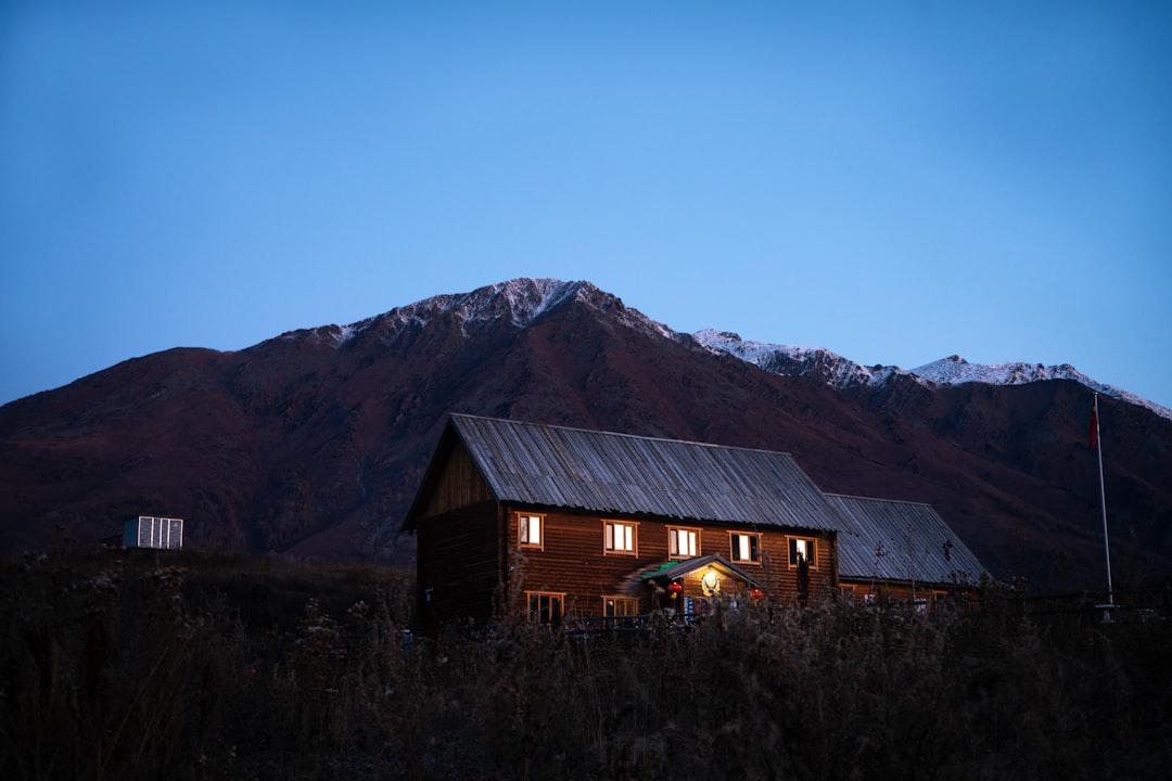 brown house near mountain during nighttime