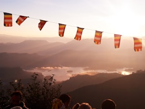 A group of Scouts from Troop 599 proudly raising their flags at sunrise.