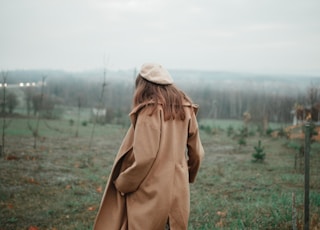 woman wears brown coat