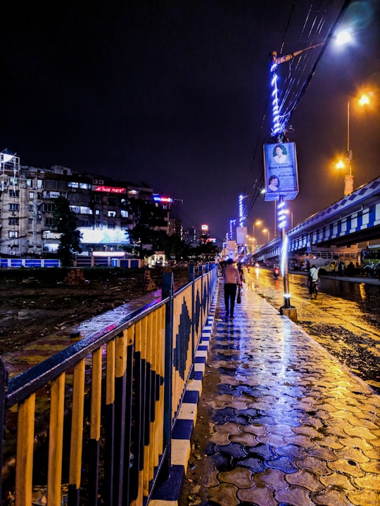 woman walks near the fence in Kolkata India