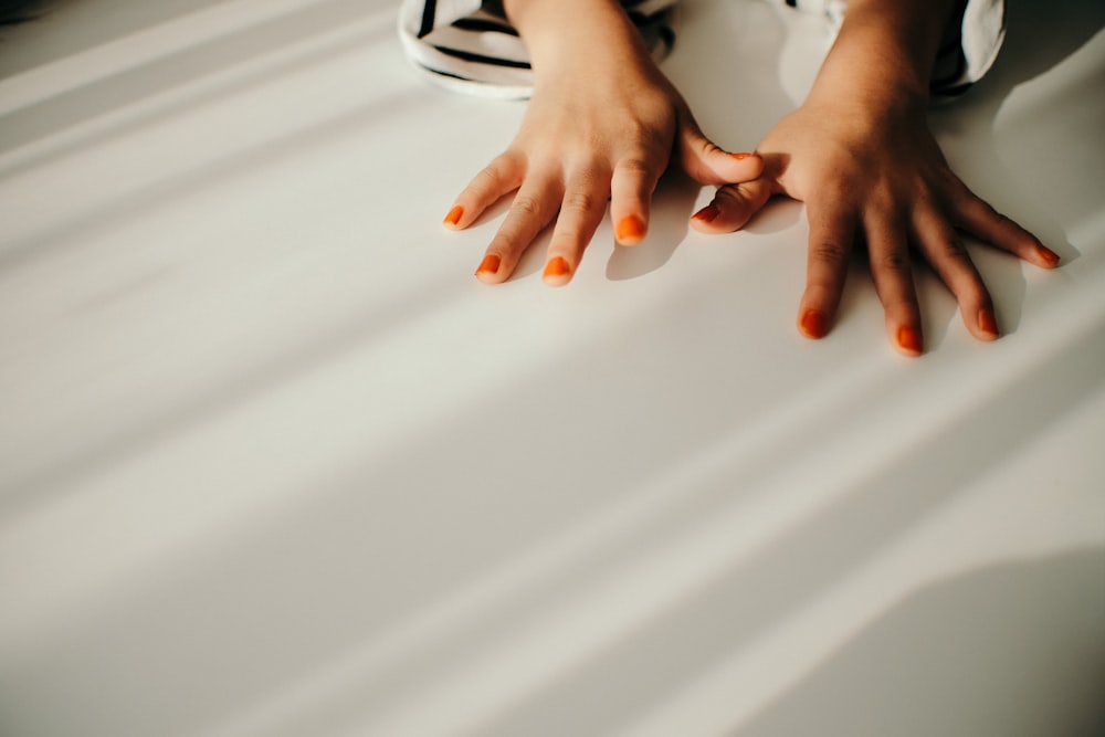 woman with orange manicure