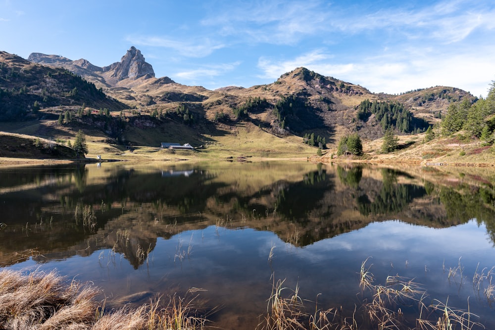 reflection of mountain on body of water during daytime