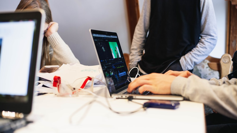 people sitting while using laptops