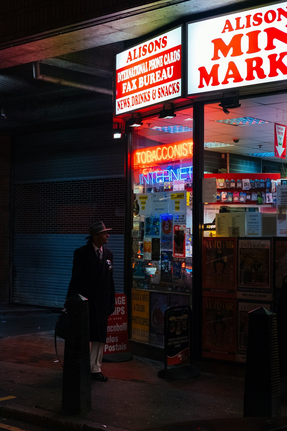 man standing in front of Alisons store