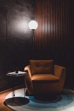 A cozy living room setup featuring a stylish lamp and comfortable chair