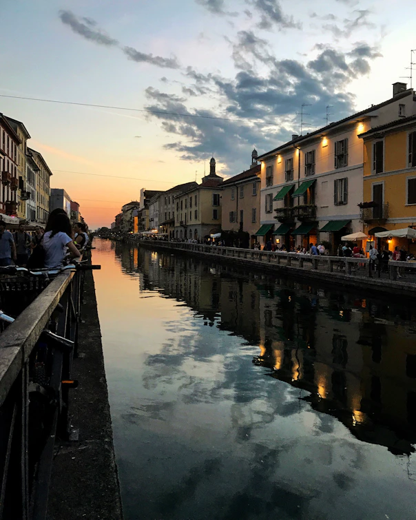 person standing near calm body of water