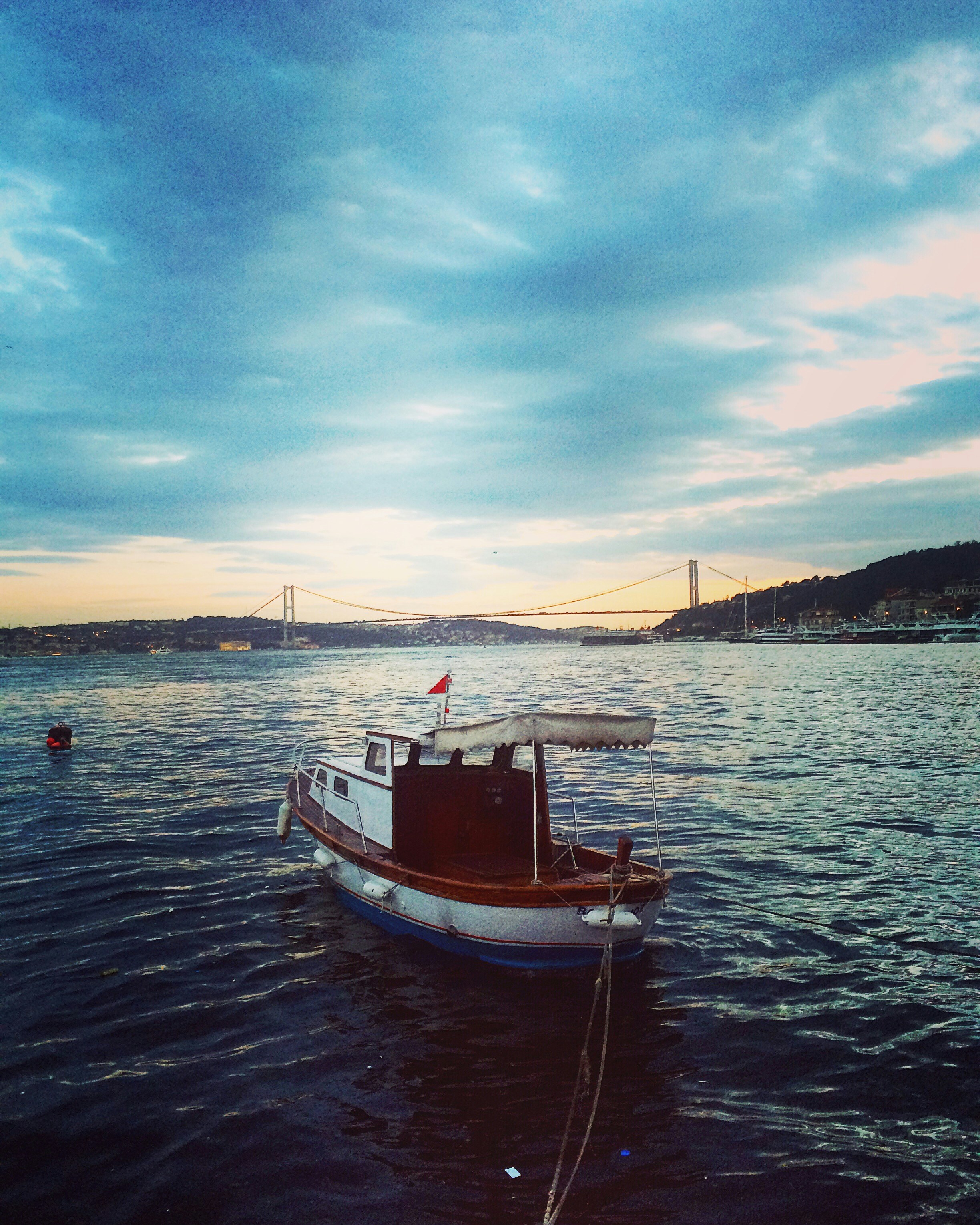 white and brown boat on body of water