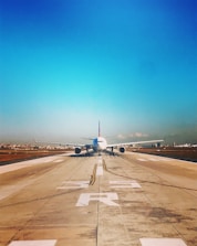 white passenger plane on roadway