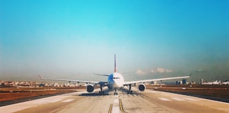 white passenger plane on roadway