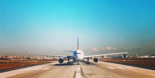 white passenger plane on roadway