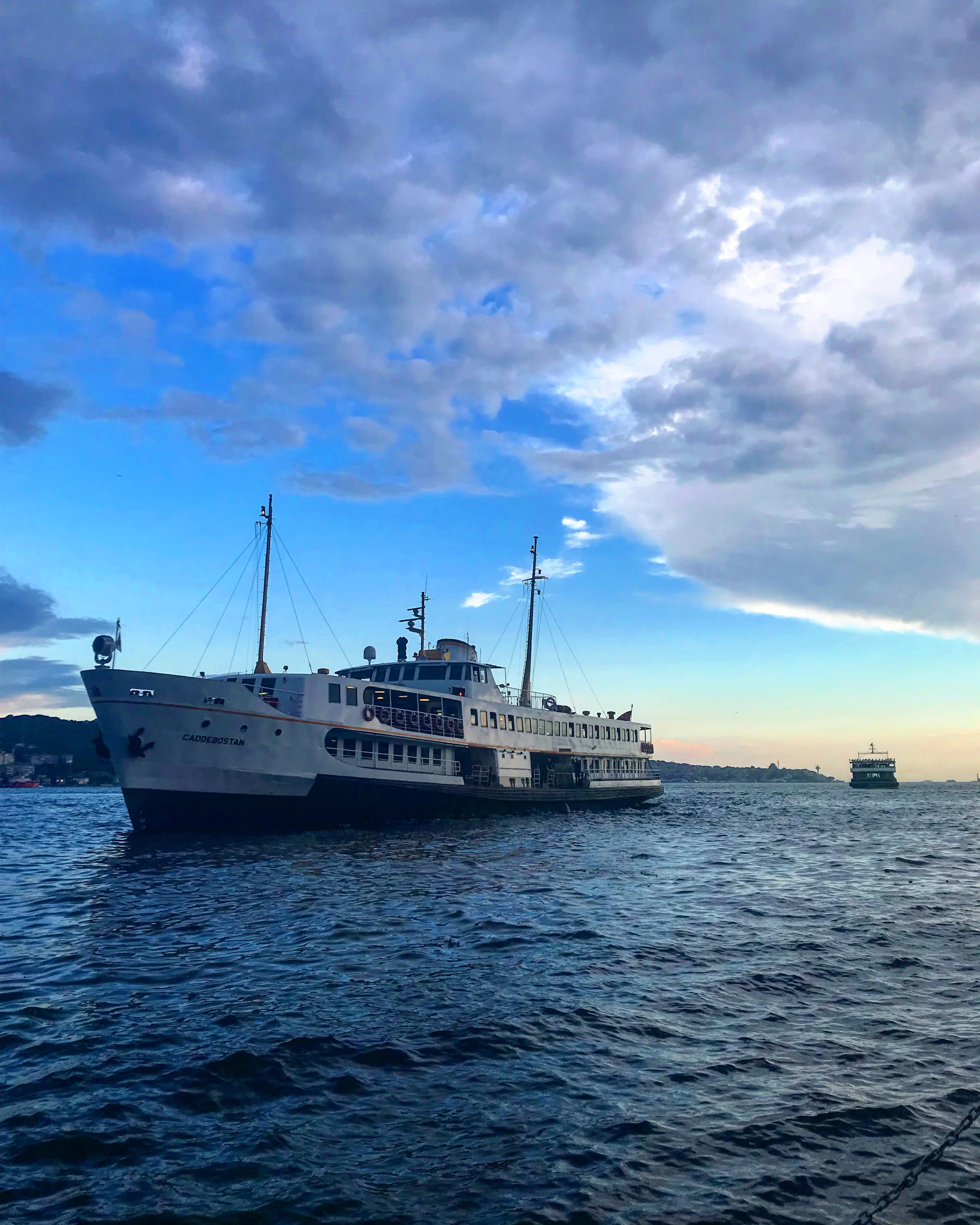 white cruise boat on body of water