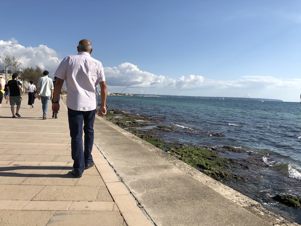 man walking on the seaside promenade