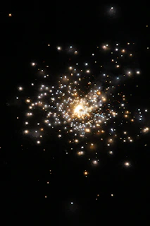 Soft glowing stars scattered across a dark cosmic backdrop with subtle gold highlights.