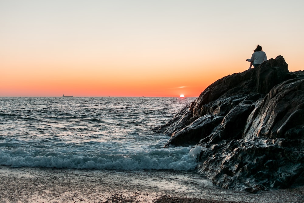 person sitting on rock