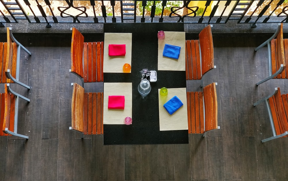 rectangular black table with four brown chairs