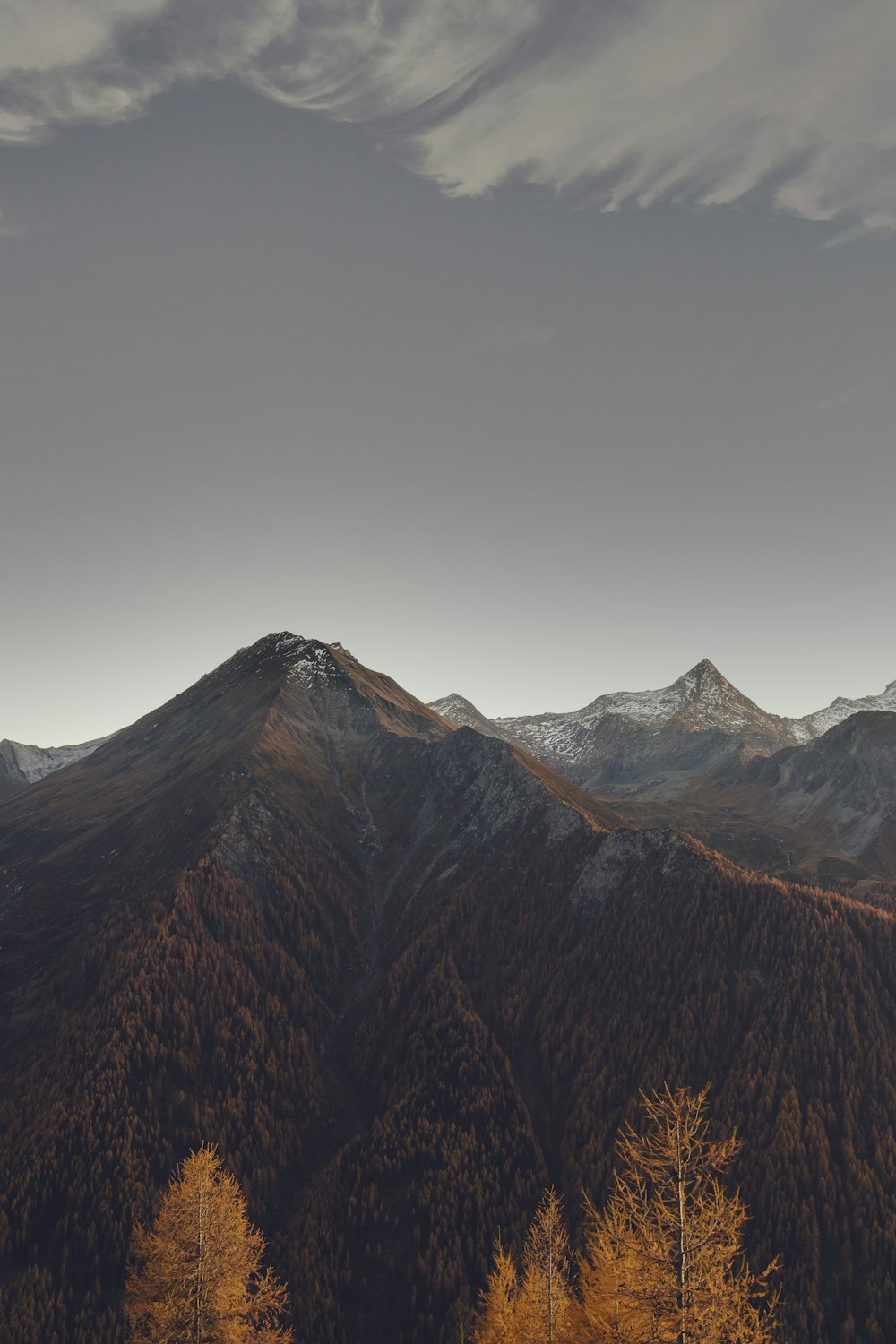 brown mountain under grey sky