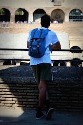 man in blue top leaning on rails