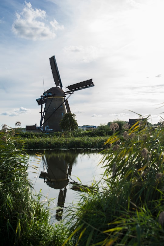 windmill beside calm body of water in Kinderdijk Netherlands