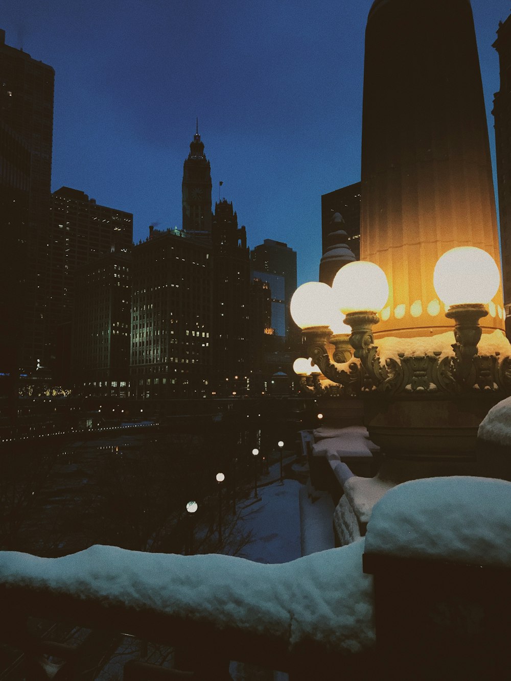 lighted post lamps by a canal in the city