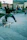 Skater performing a trick mid-air with cityscape in the background.