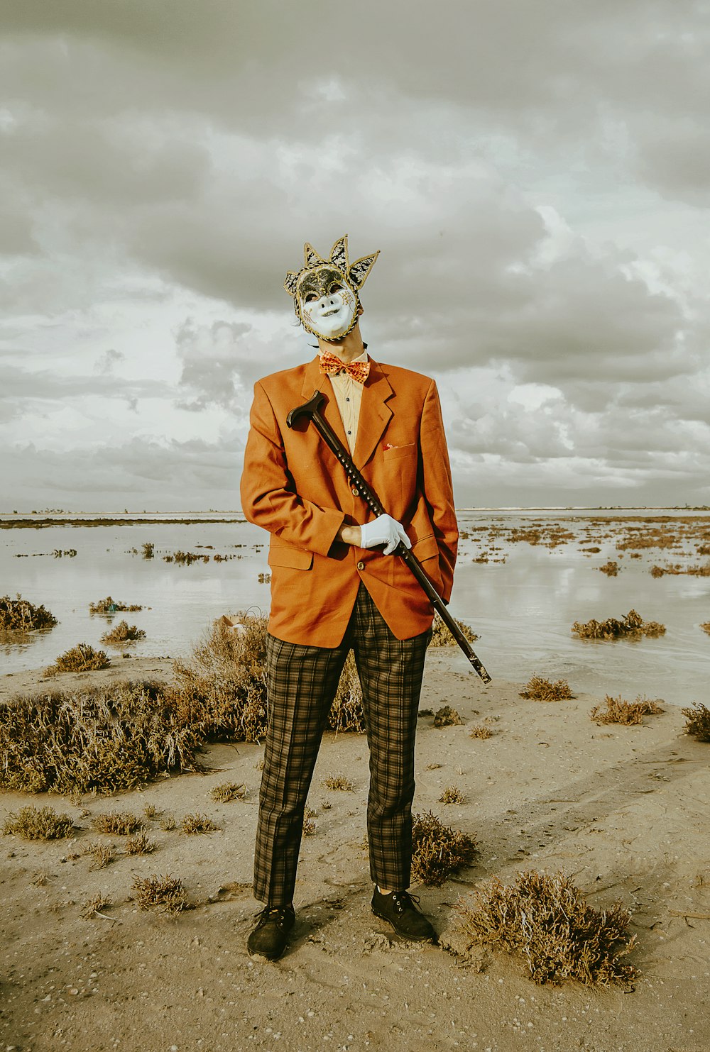 man in orange suit jacket wearing mask