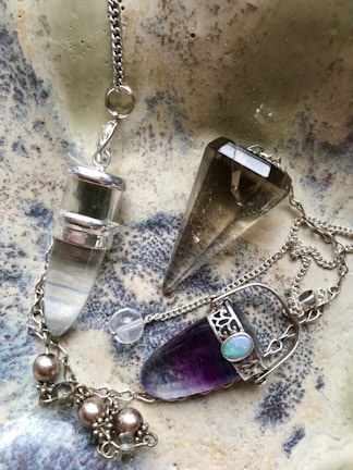 An elegant pendulum resting on a velvet cloth.