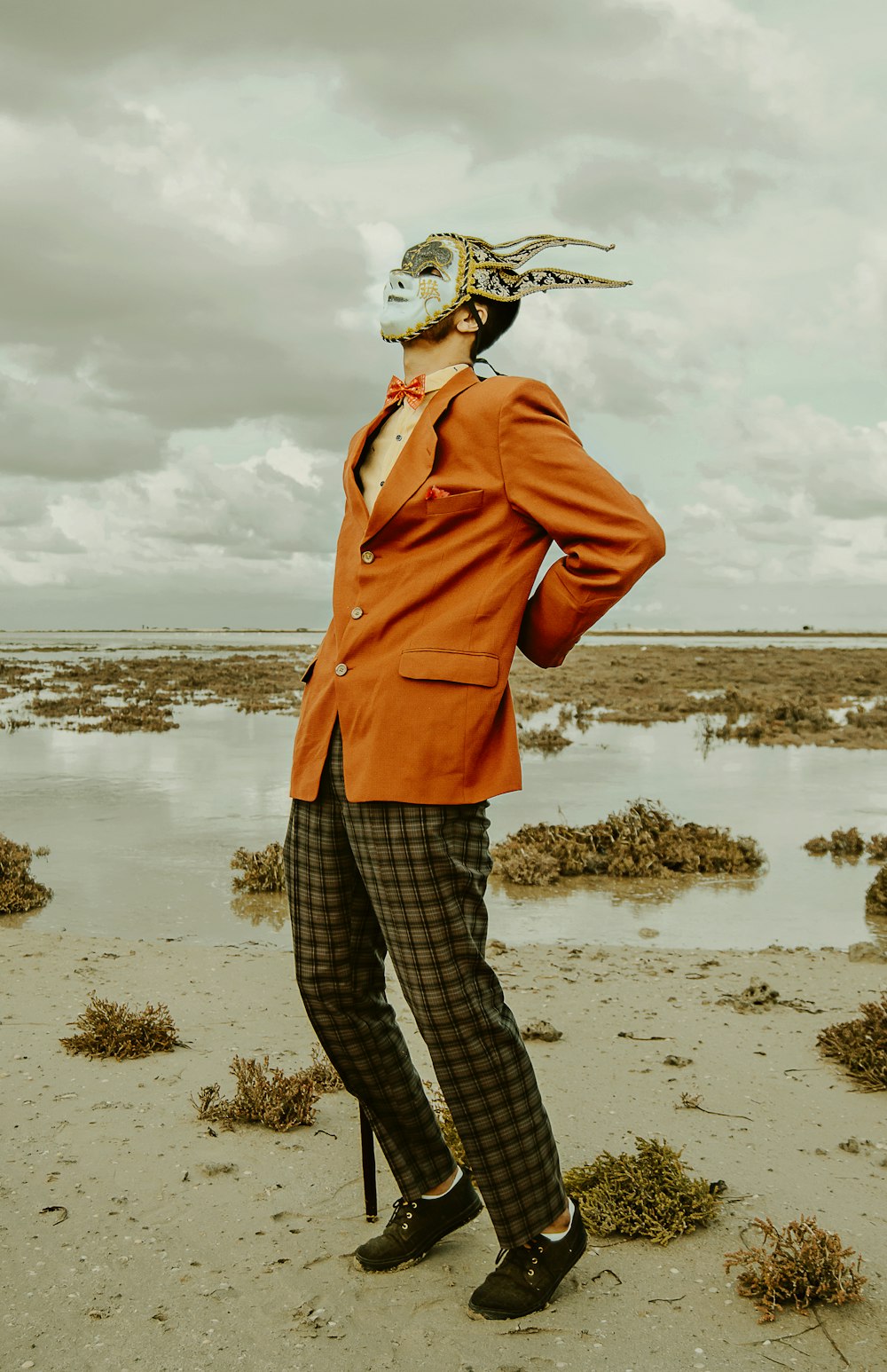 man wearing mask at beach