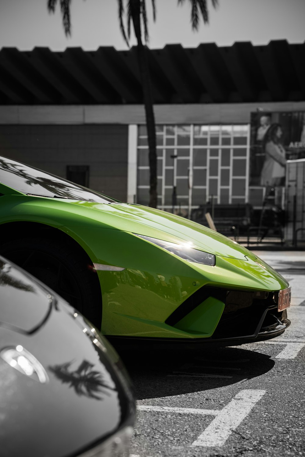 green sports car parking near house