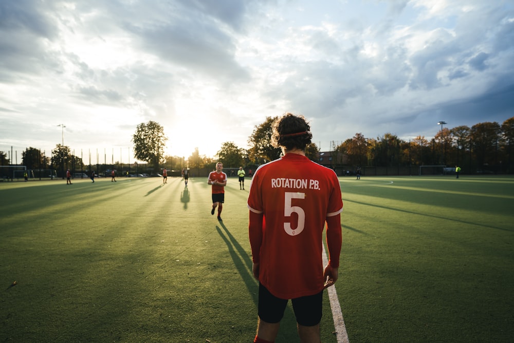 men standing at the soccer field during day