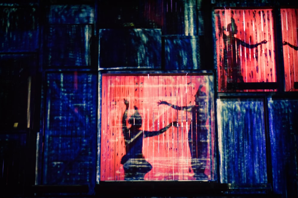 a person standing in front of a window in a building