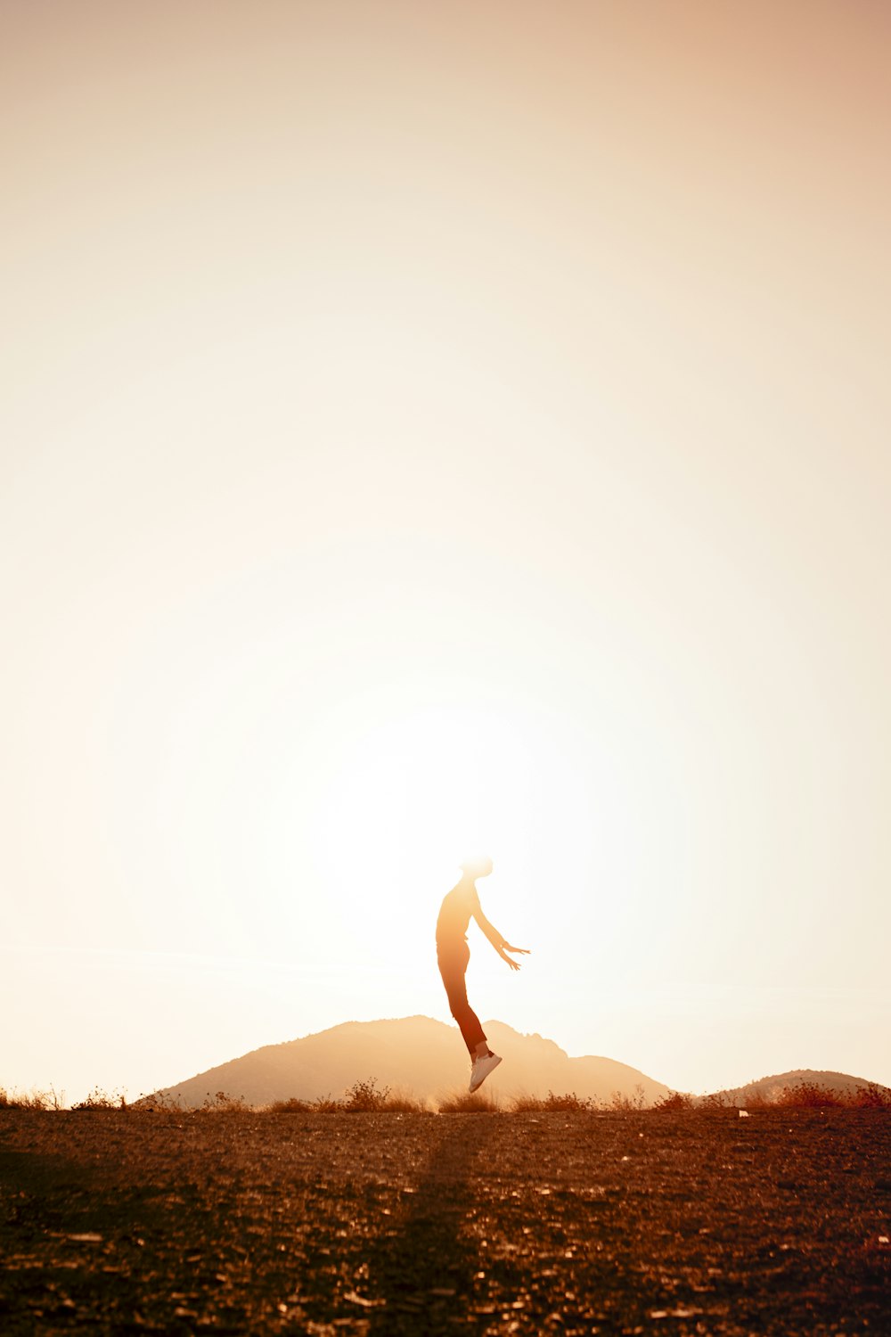 man jumping near mountain