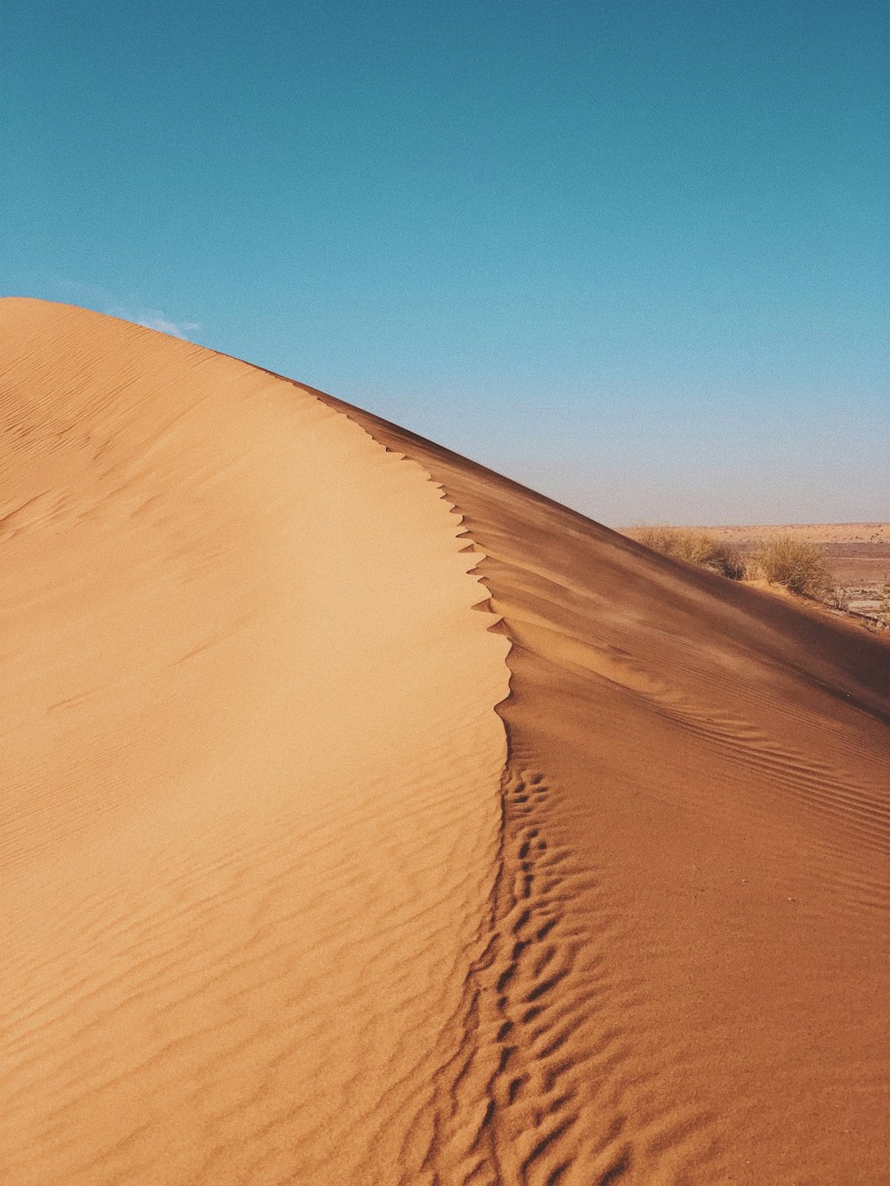 aerial photography of desert under blue and white sky during daytime