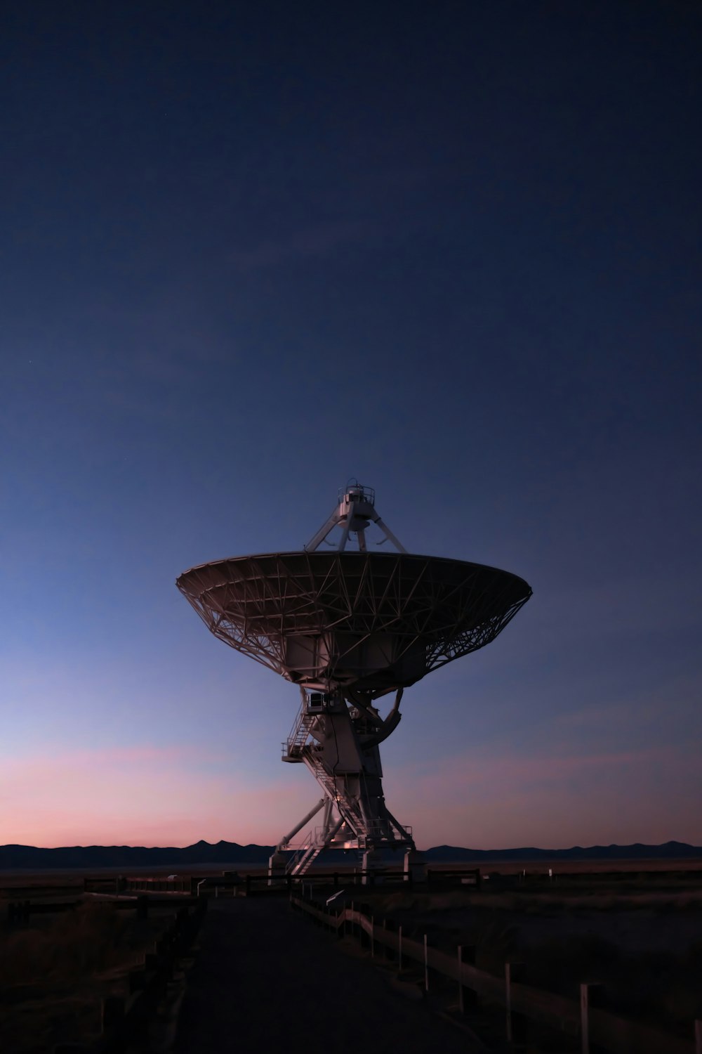 round grey satellite antenna at night