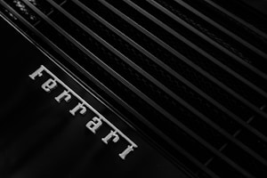 grayscale photo of Ferrari emblem