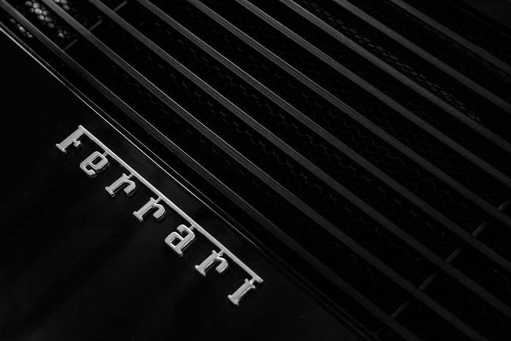 grayscale photo of Ferrari emblem