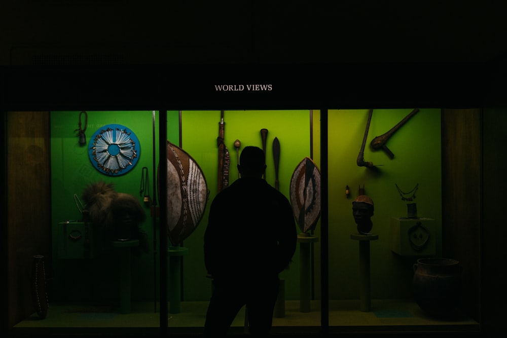 a man standing in front of a green wall